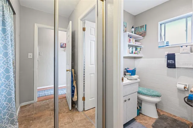 a bathroom with a toilet and a shower