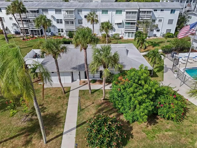 a view of swimming pool with outdoor seating and plants