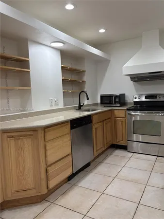 a kitchen with stainless steel appliances granite countertop a sink and cabinets