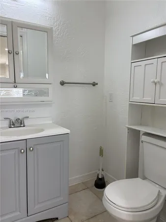 a bathroom with a sink a toilet and vanity