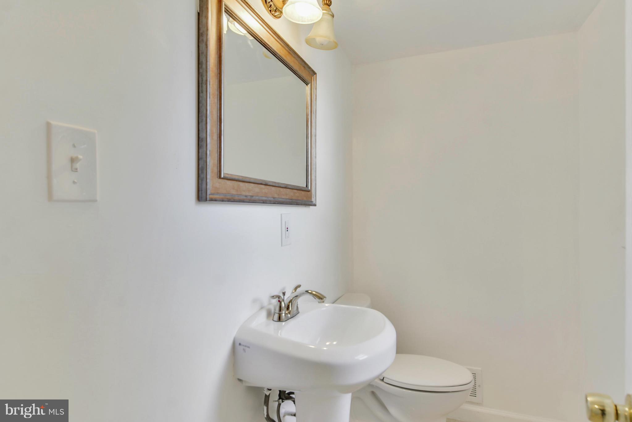 1409 Jackson Road Silver Spring, MD 20904 - Photo 13 of 30 a bathroom with a sink mirror and toilet