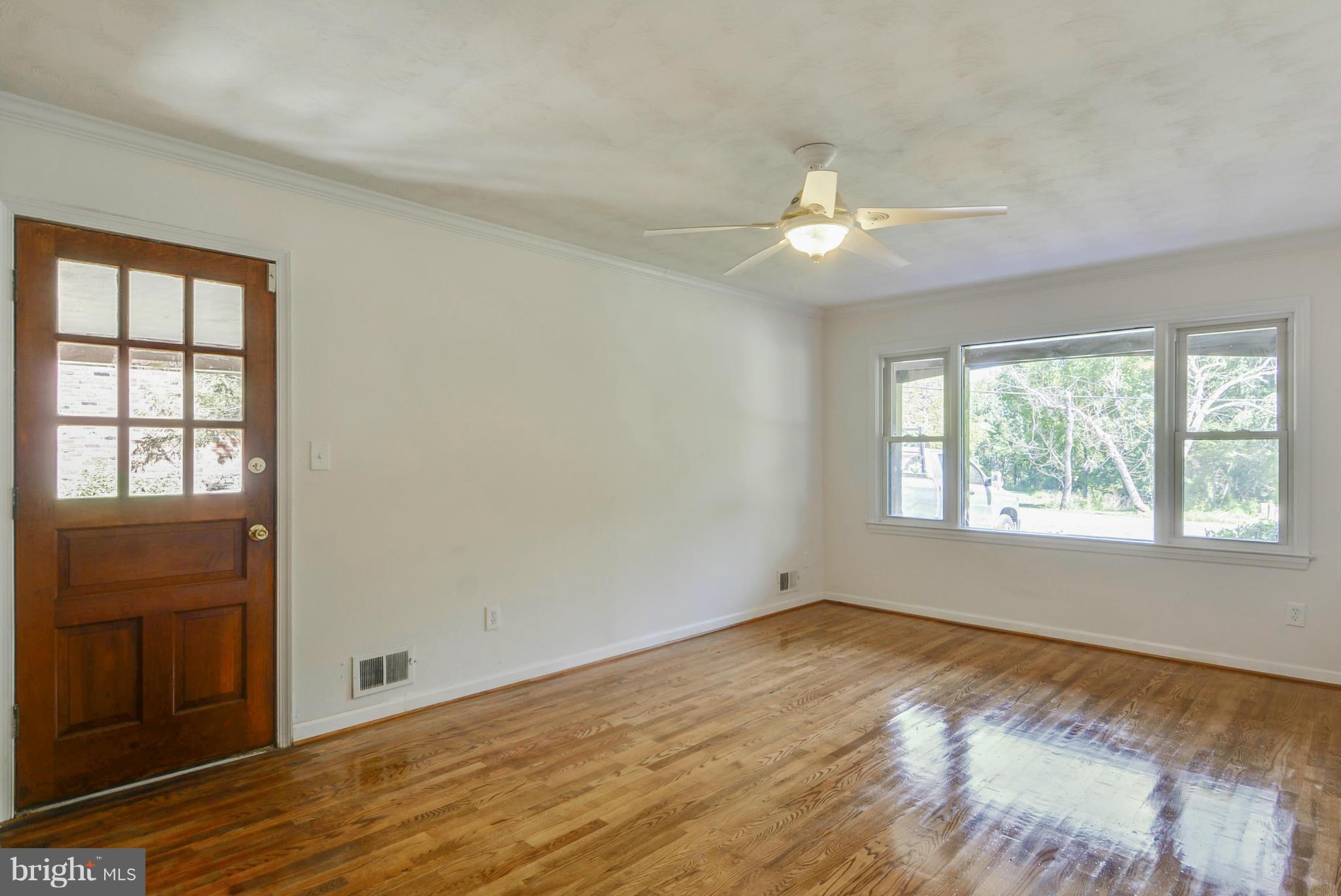 1409 Jackson Road Silver Spring, MD 20904 - Photo 15 of 30 a view of an empty room with wooden floor and a window