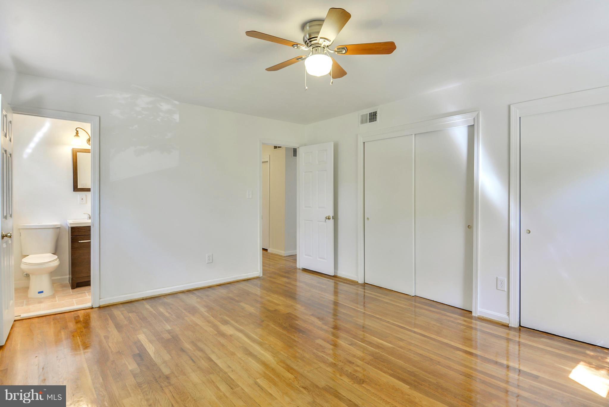 1409 Jackson Road Silver Spring, MD 20904 - Photo 16 of 30 a view of a room with wooden floor and a ceiling fan