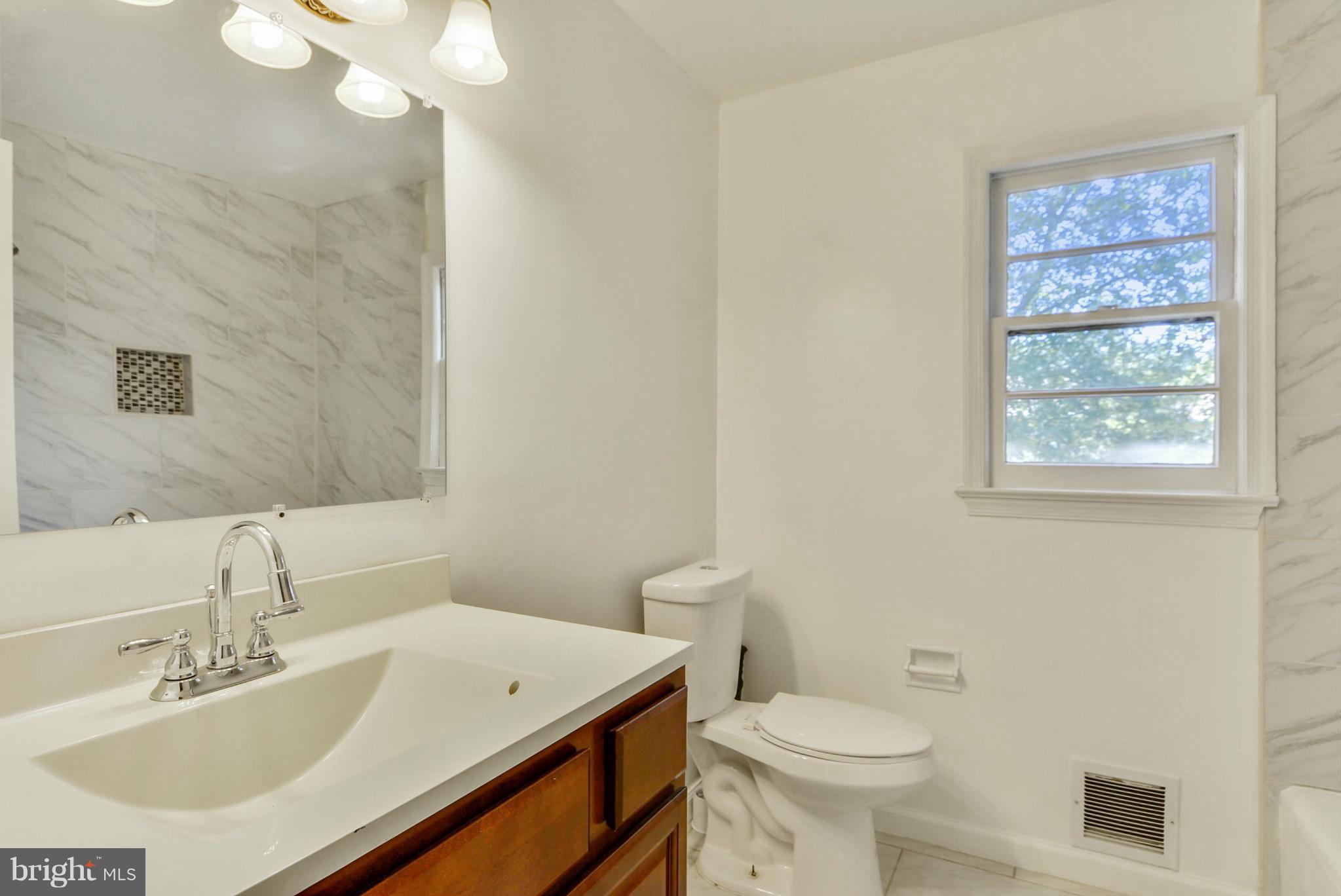 1409 Jackson Road Silver Spring, MD 20904 - Photo 20 of 30 a bathroom with a sink a toilet and a mirror