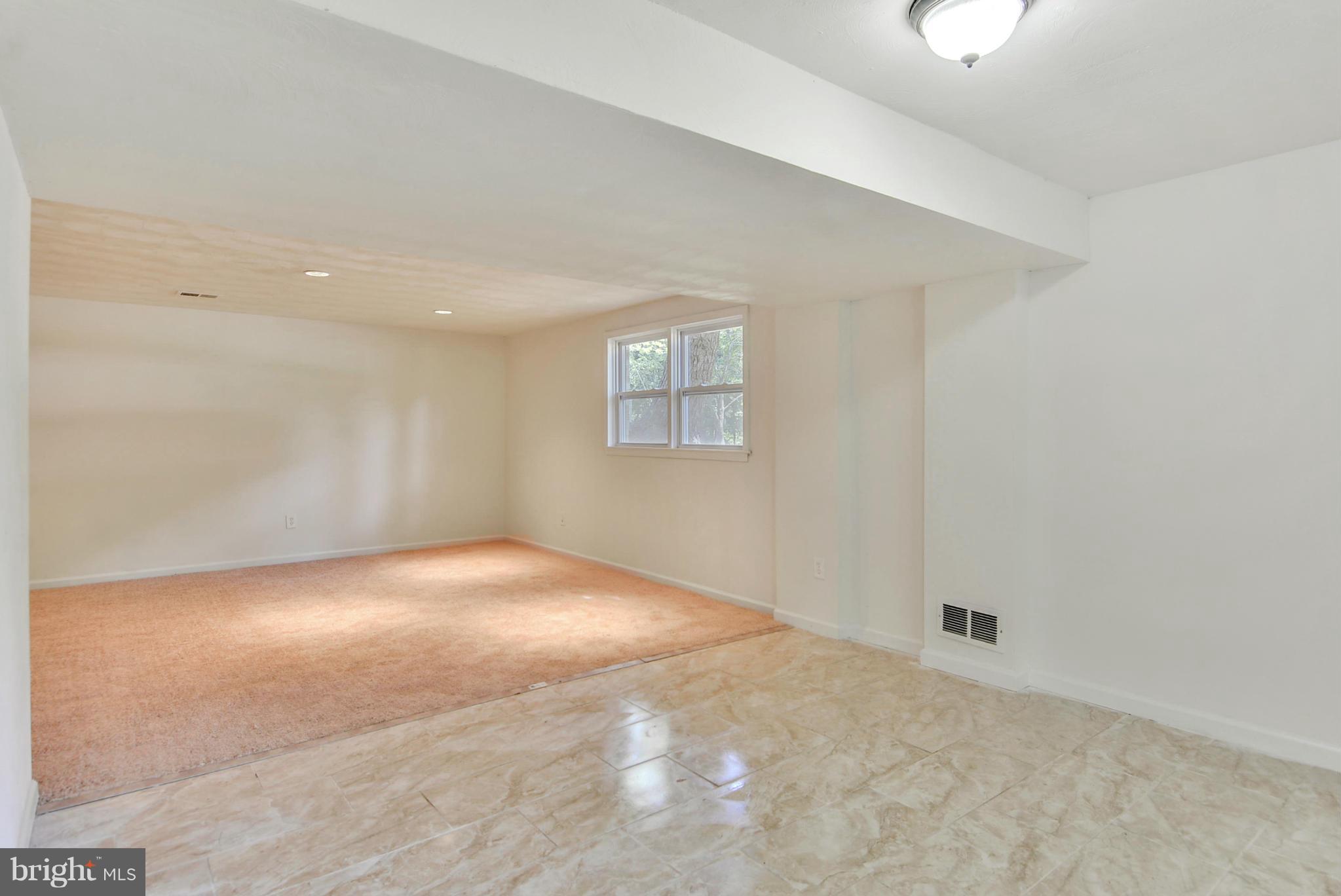 1409 Jackson Road Silver Spring, MD 20904 - Photo 23 of 30 an empty room with a window and a ceiling fan