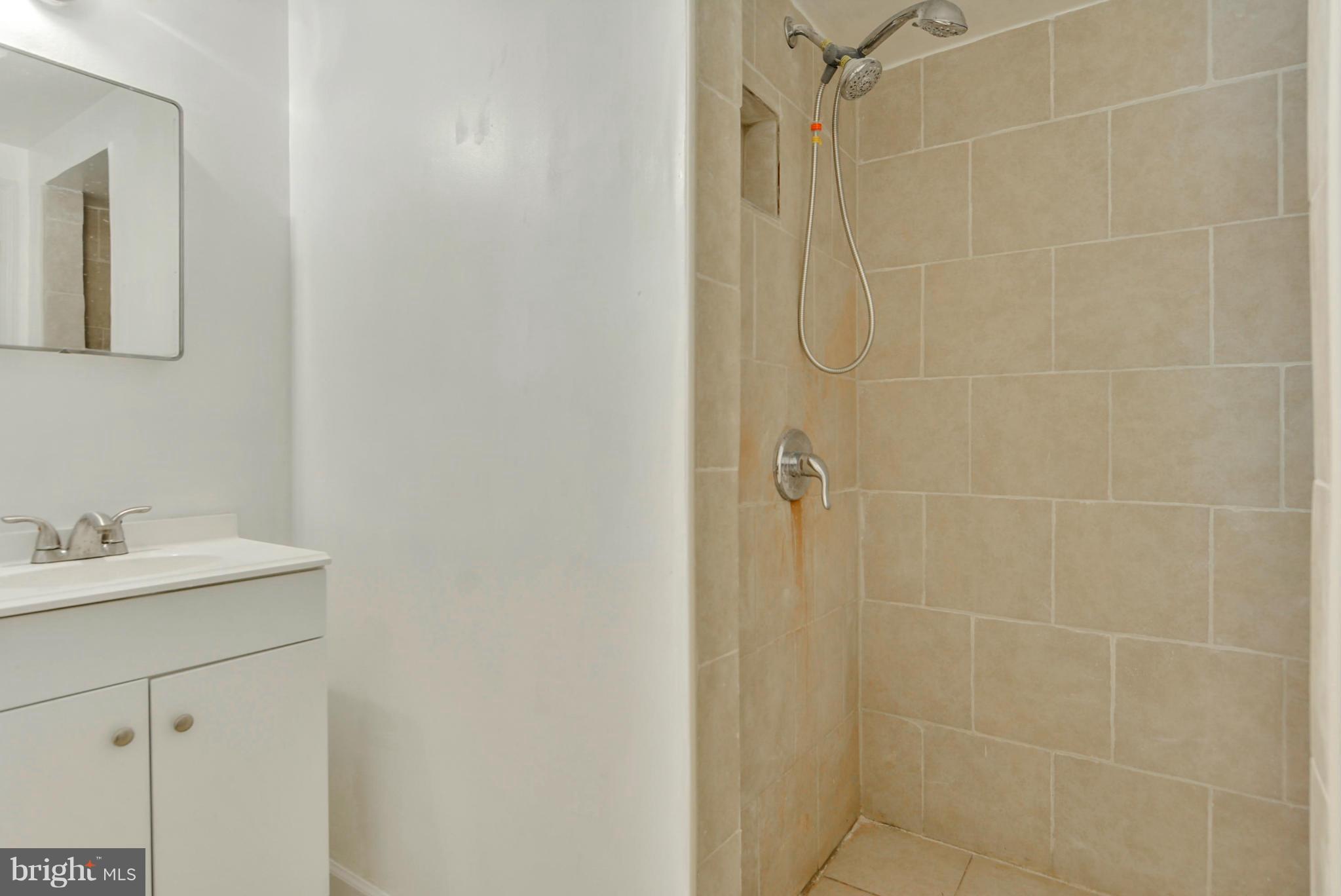 1409 Jackson Road Silver Spring, MD 20904 - Photo 25 of 30 a bathroom with a sink vanity and a mirror