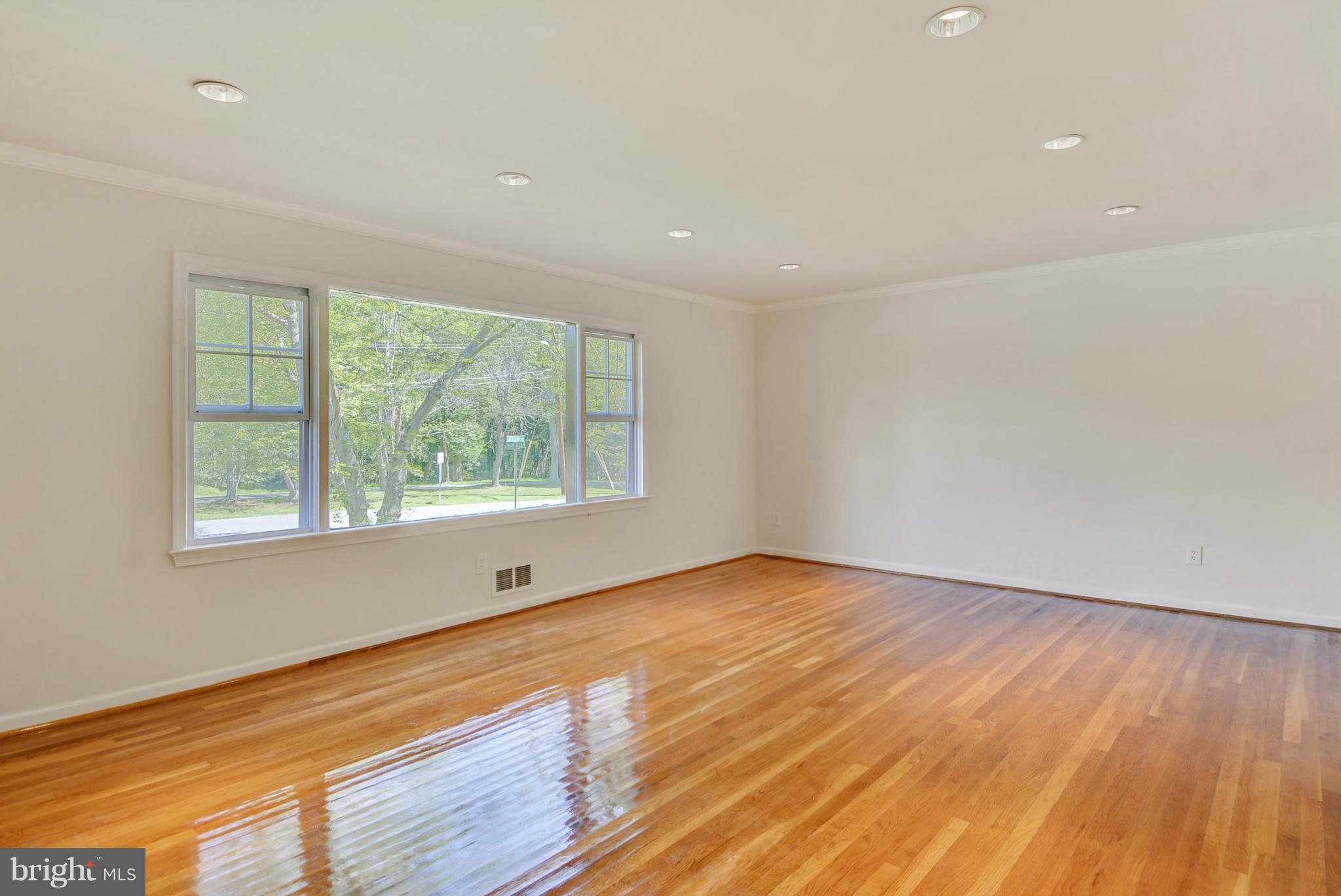 1409 Jackson Road Silver Spring, MD 20904 - Photo 6 of 30 a view of an empty room with wooden floor and a window