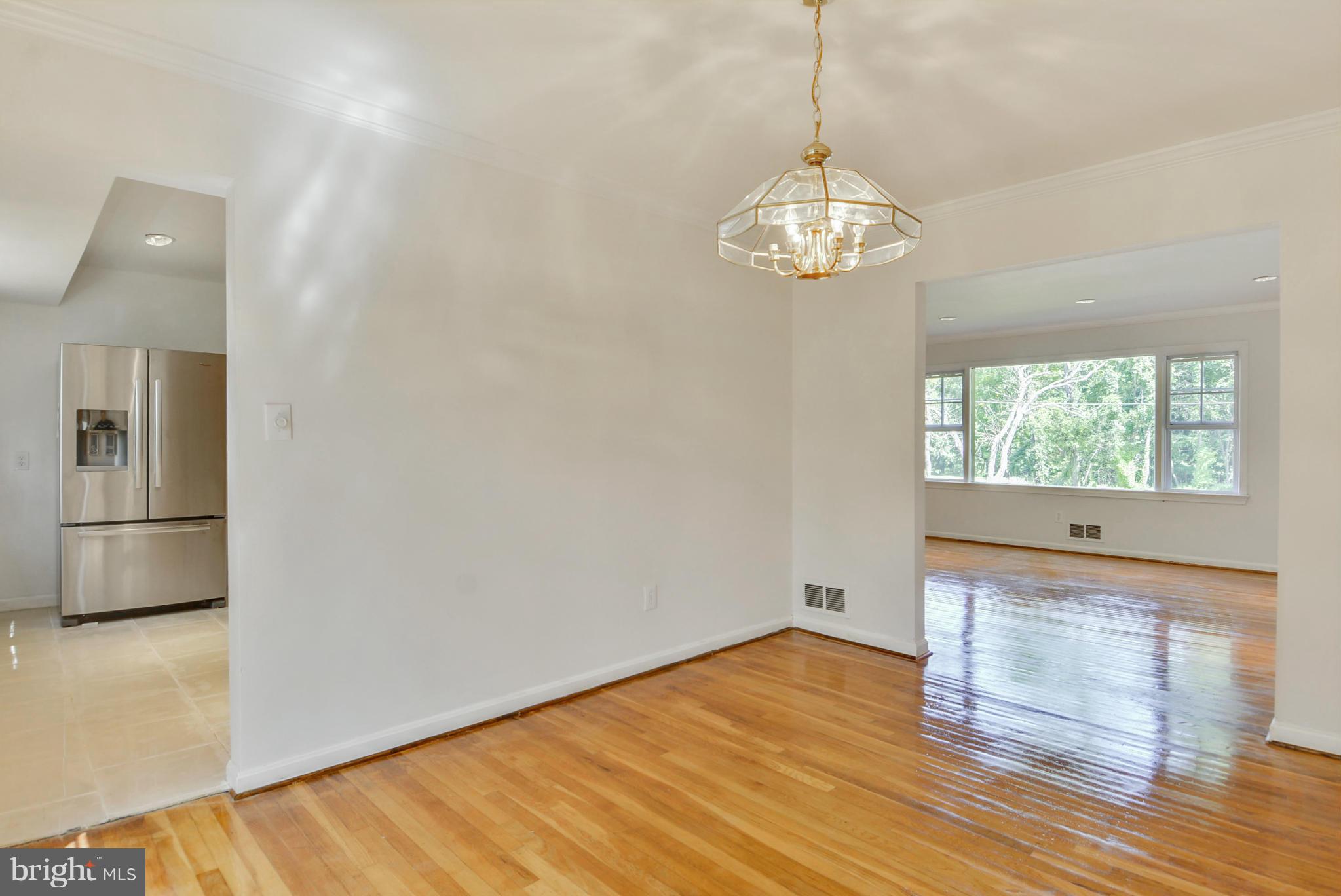1409 Jackson Road Silver Spring, MD 20904 - Photo 8 of 30 a view of a room with wooden floor chandelier and windows