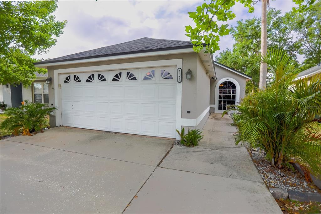 2083 Windward Pass Lakeland, FL 33813 - Photo 1 of 15 a front view of a house with plants