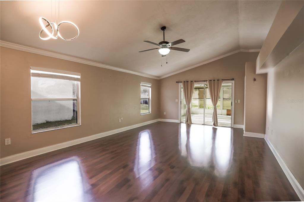 2083 Windward Pass Lakeland, FL 33813 - Photo 5 of 15 a view of an empty room with wooden floor and a window