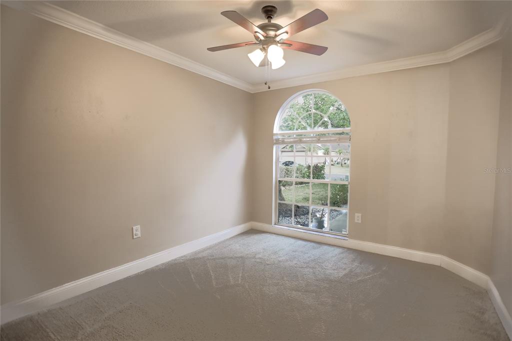 2083 Windward Pass Lakeland, FL 33813 - Photo 6 of 15 an empty room with a window and a fan