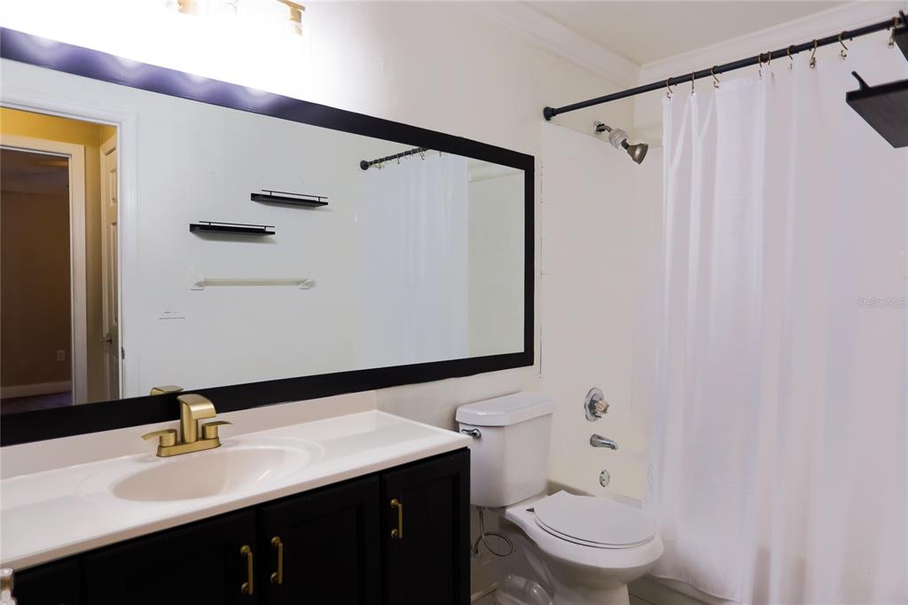 2083 Windward Pass Lakeland, FL 33813 - Photo 7 of 15 a bathroom with a sink a toilet and shower