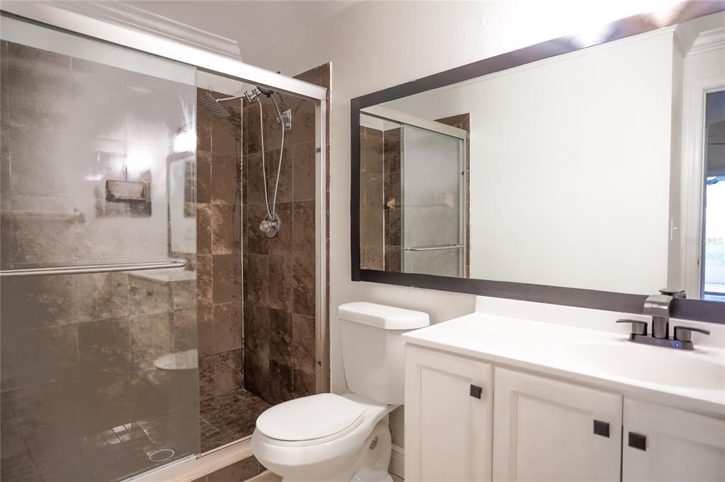 2083 Windward Pass Lakeland, FL 33813 - Photo 9 of 15 a bathroom with a sink a toilet and shower