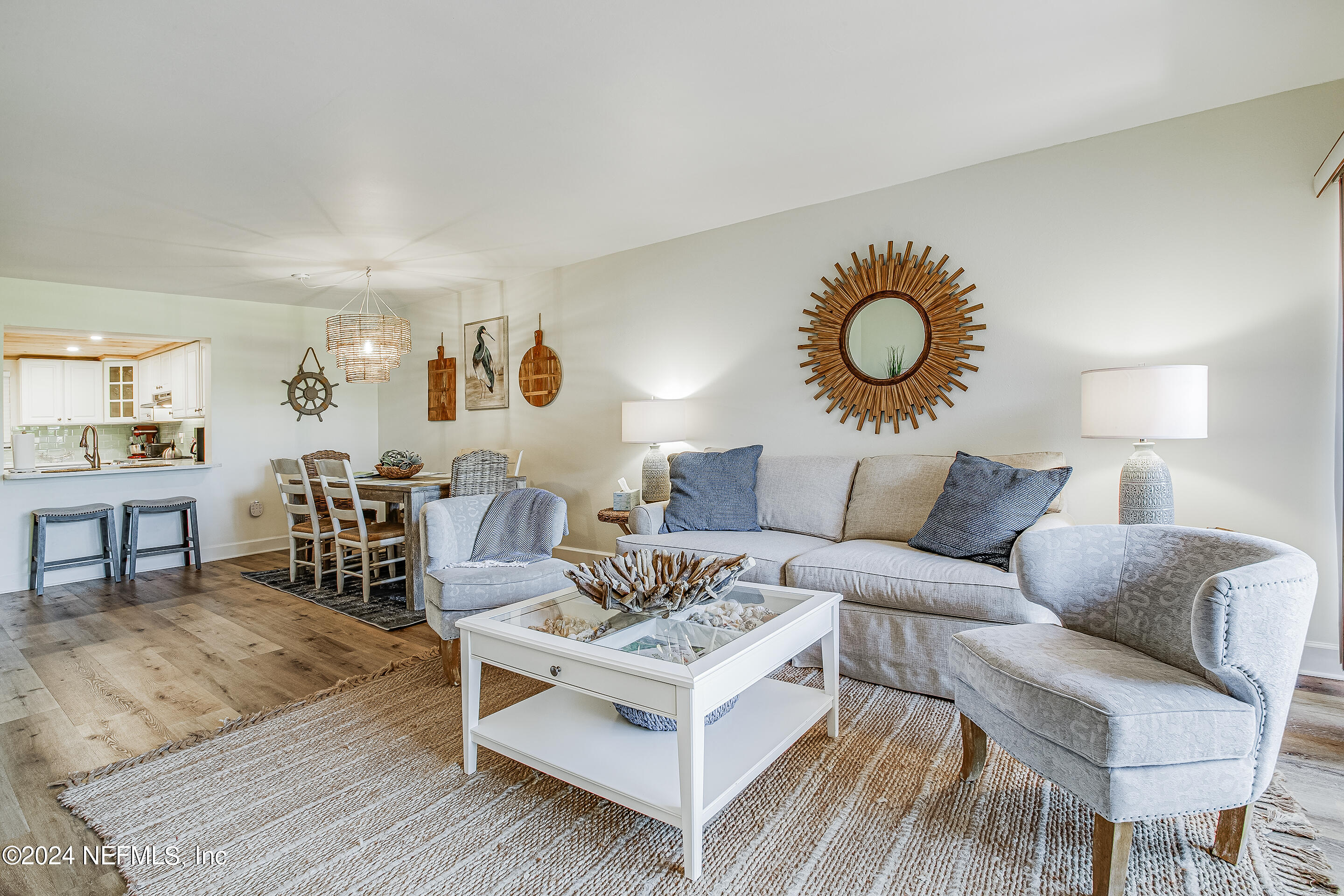 4 Ocean Trace Road, Unit 102 St. Augustine, FL 32080 - Photo 11 of 37 a living room with furniture and wooden floor