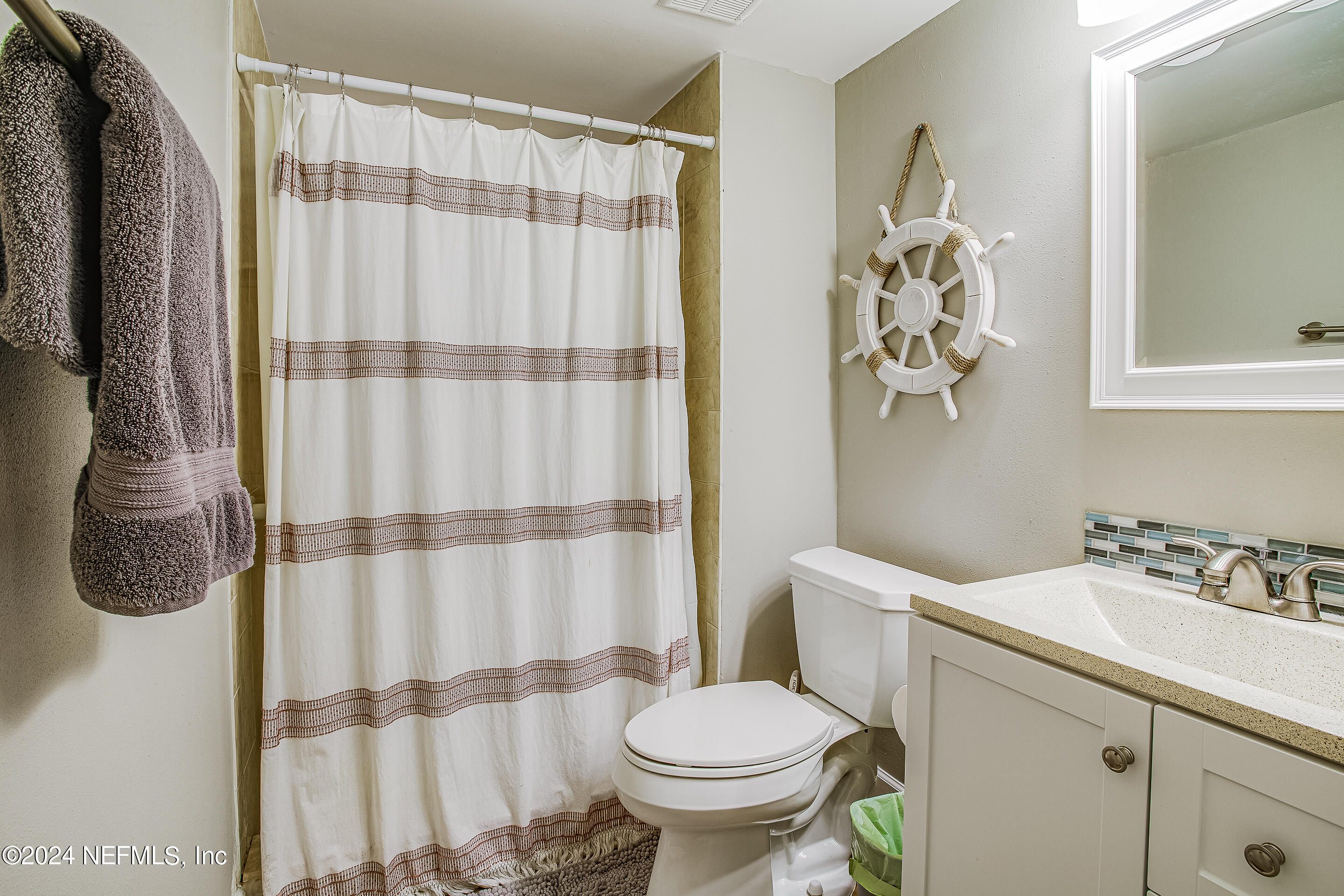 4 Ocean Trace Road, Unit 102 St. Augustine, FL 32080 - Photo 15 of 37 a bathroom with a sink toilet and shower