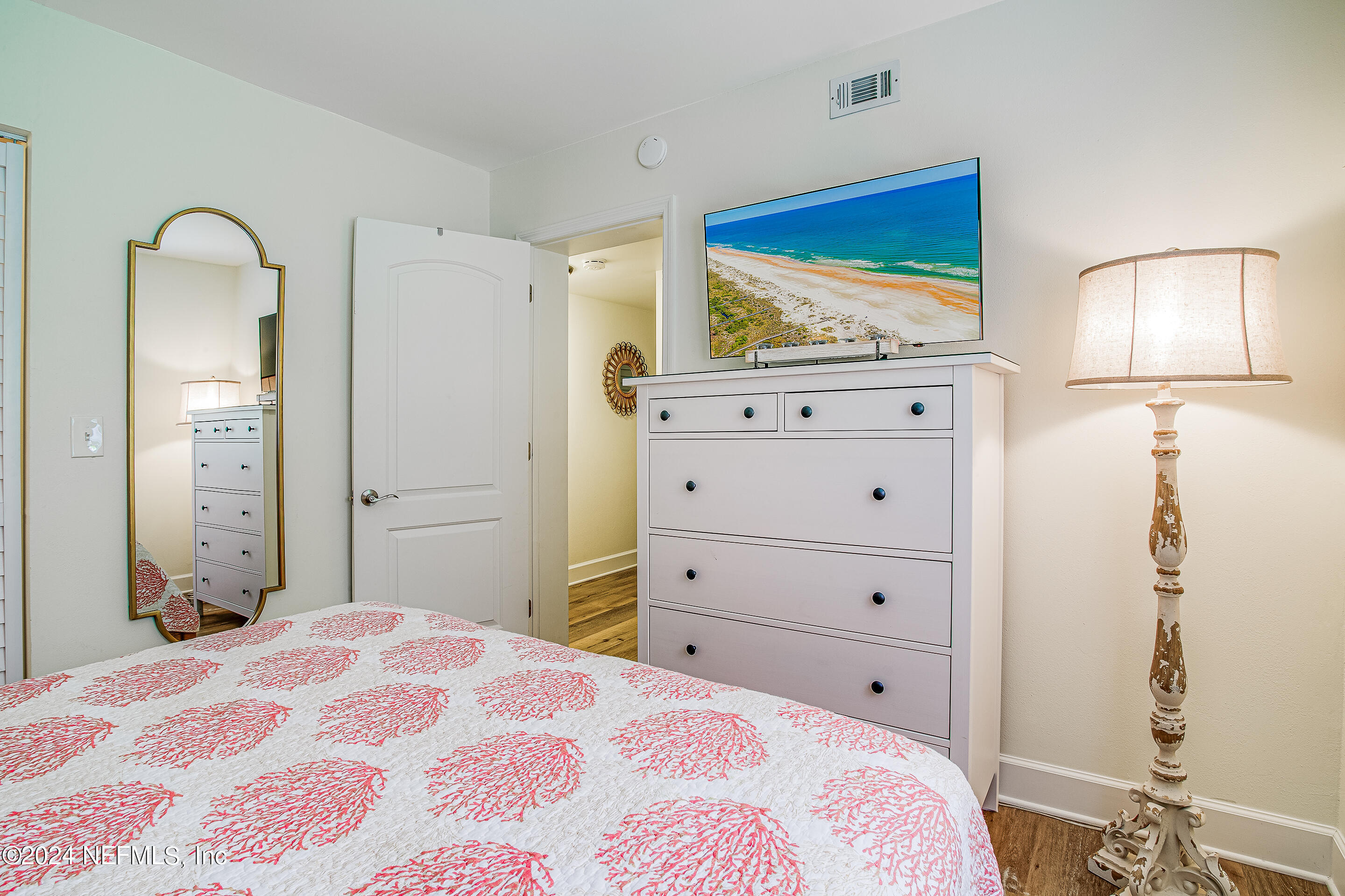 4 Ocean Trace Road, Unit 102 St. Augustine, FL 32080 - Photo 17 of 37 a bedroom with a bed and a mirror