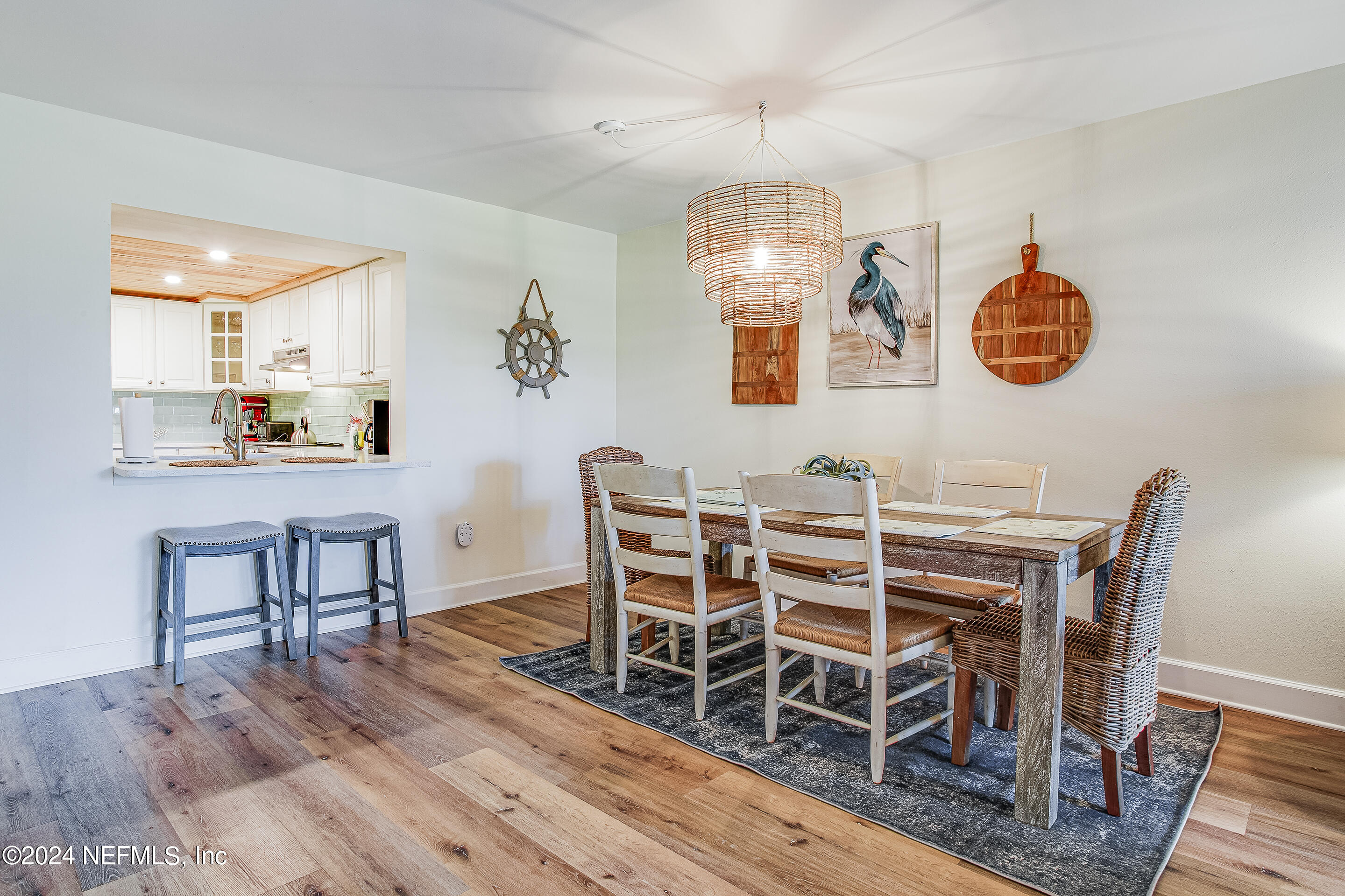 4 Ocean Trace Road, Unit 102 St. Augustine, FL 32080 - Photo 7 of 37 a view of a dining room with furniture wooden floor and chandelier