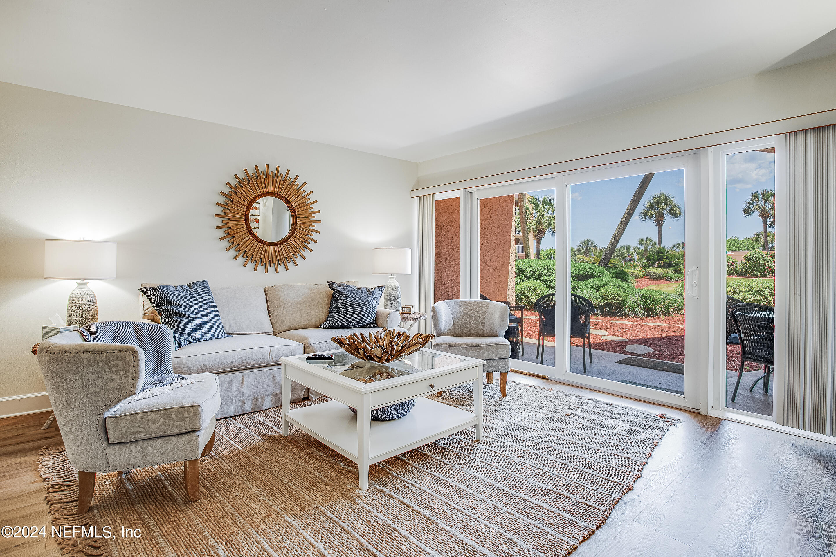 4 Ocean Trace Road, Unit 102 St. Augustine, FL 32080 - Photo 9 of 37 a living room with furniture and a large window