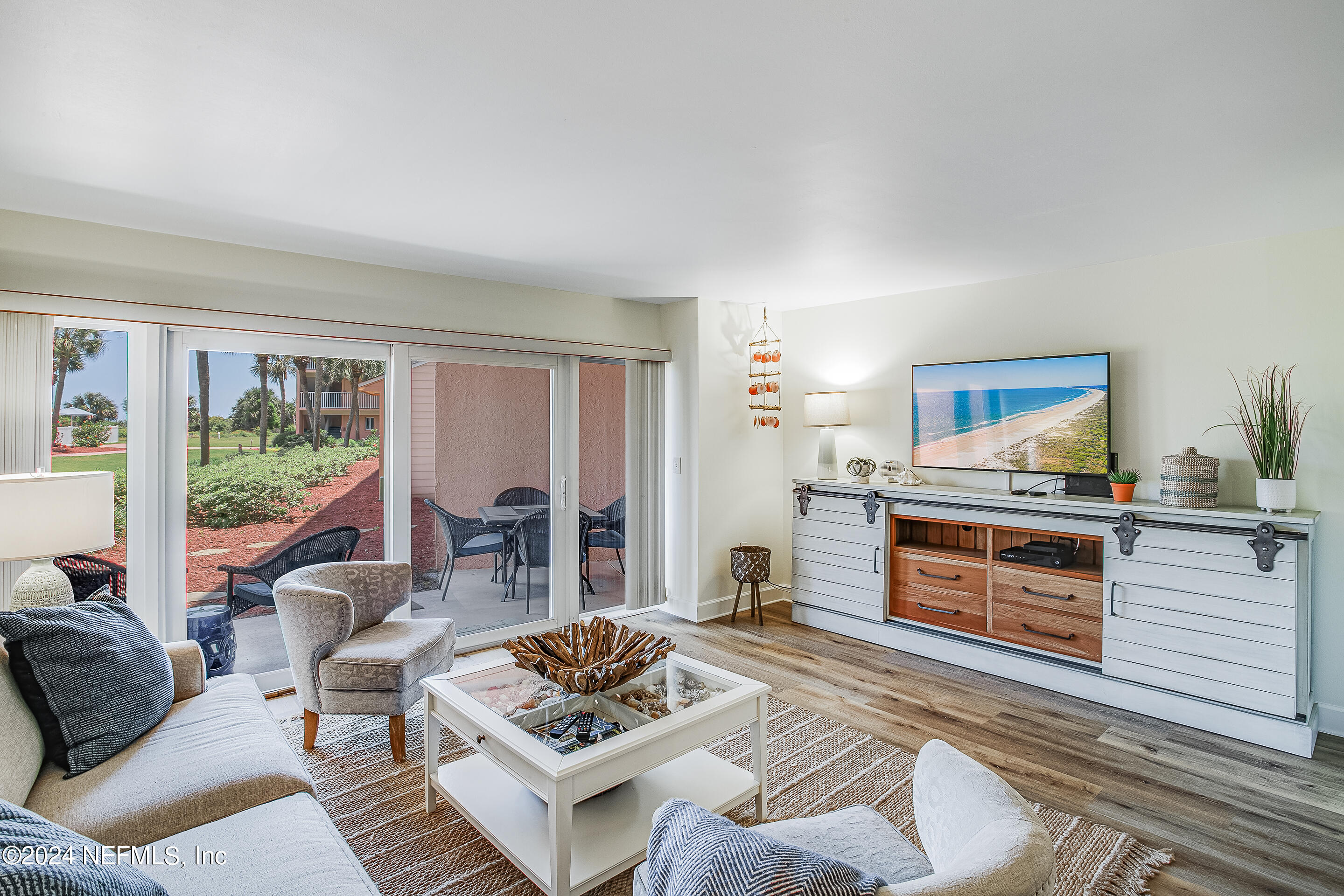 4 Ocean Trace Road, Unit 102 St. Augustine, FL 32080 - Photo 10 of 37 a living room with furniture and a open kitchen view