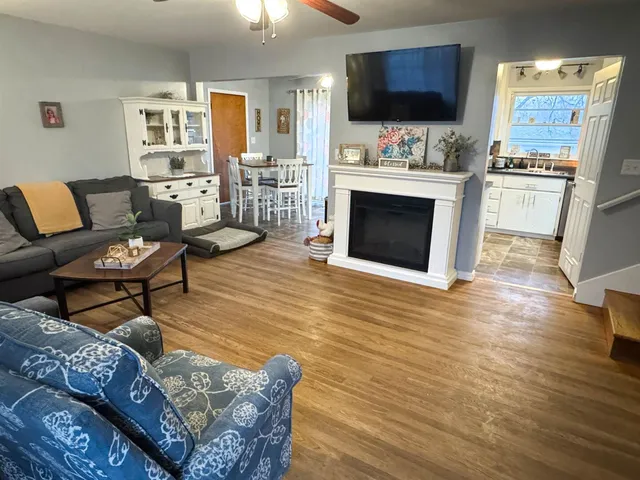 a living room with furniture fireplace and flat screen tv