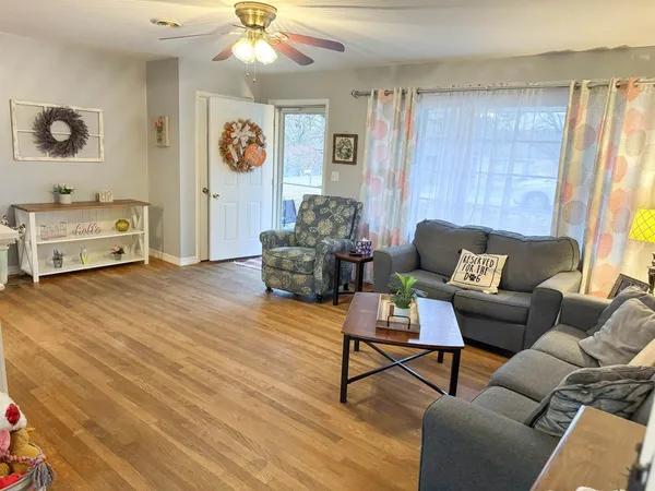 a living room with furniture and a wooden floor