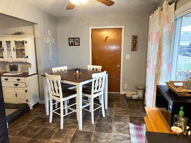 a dining room with furniture and window