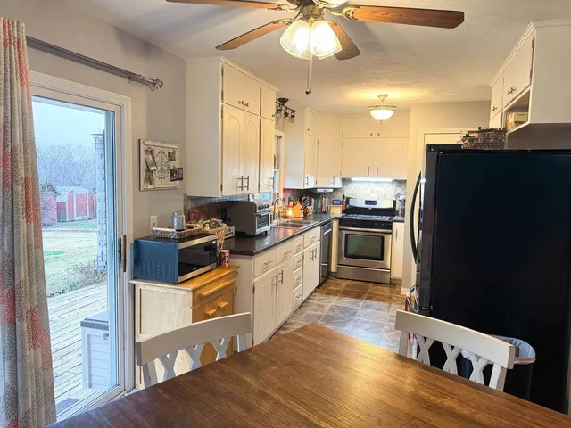 a kitchen with stainless steel appliances a stove a sink and a refrigerator