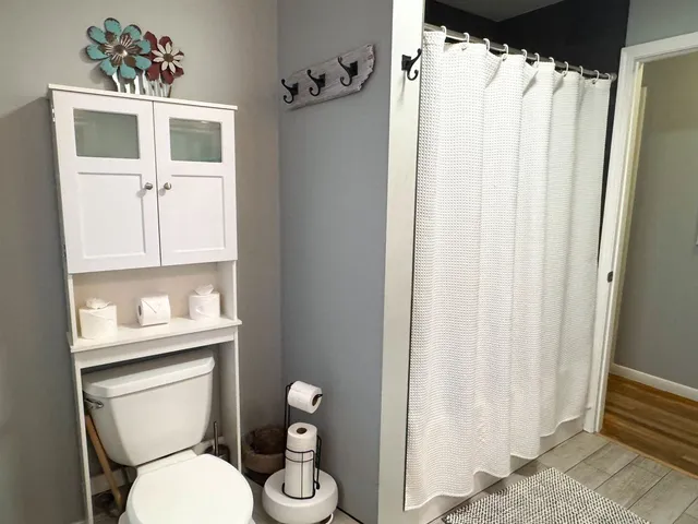 a white toilet sitting next to a bathroom sink
