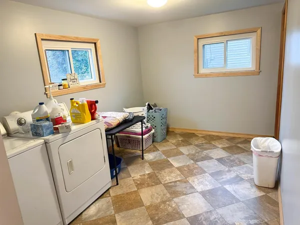 a room with a baby bed furniture and a window