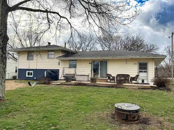 a view of a house with backyard porch and sitting area
