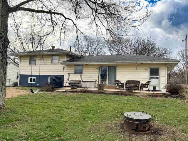 a view of a house with backyard porch and sitting area