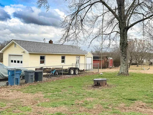 a view of a house with backyard porch and sitting area