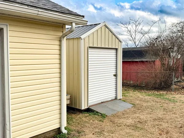 a view of a house with a yard and garage