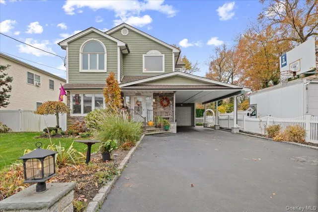 a view of a house with a yard and sitting area