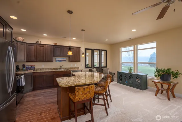 a large kitchen with a table and chairs