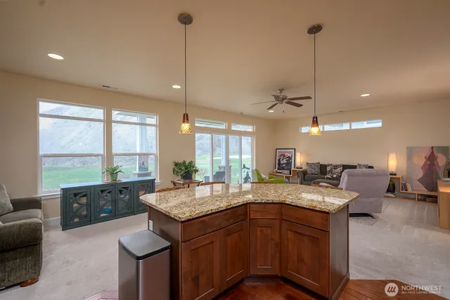 a kitchen with a sink a center island and furniture