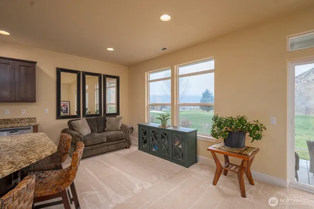 a living room with furniture and a potted plant