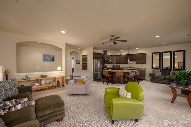 a living room with furniture and kitchen view