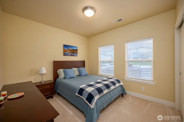 a bedroom with a bed lamp and a window