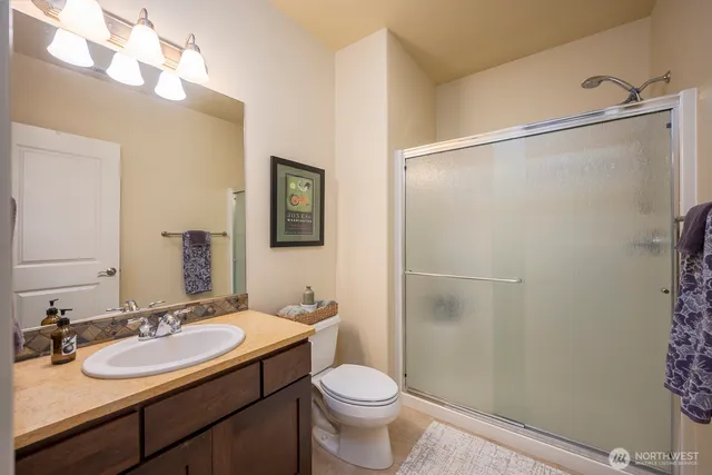 a bathroom with a sink toilet and shower