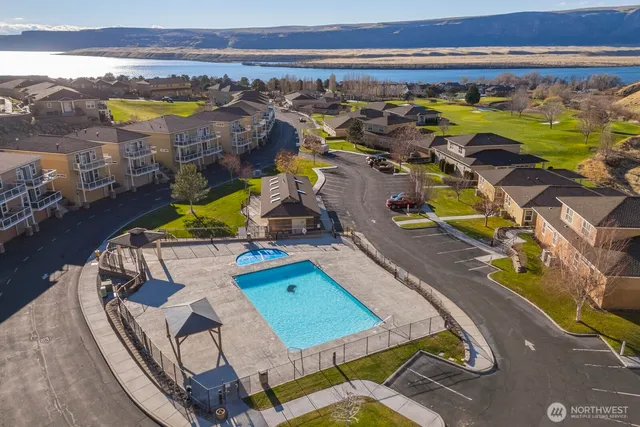 a view of a swimming pool with outdoor seating and city view
