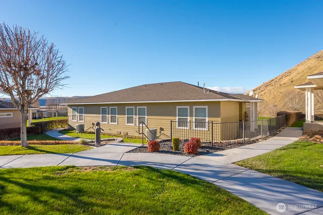 a view of a house with swimming pool and sitting area