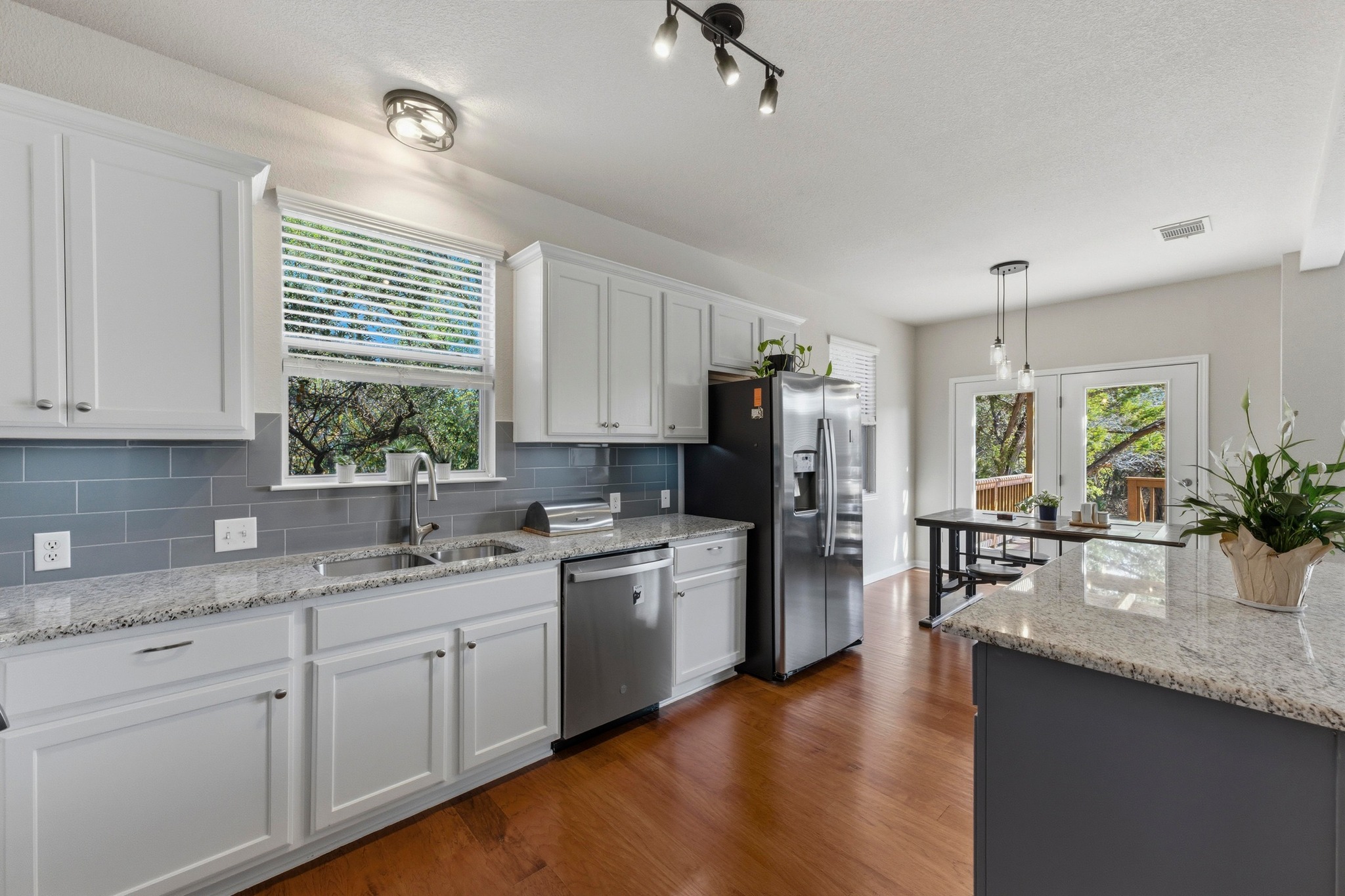7805 Pitter Pat Lane Austin, TX 78736 - Photo 12 of 40 a kitchen with a sink stove and refrigerator
