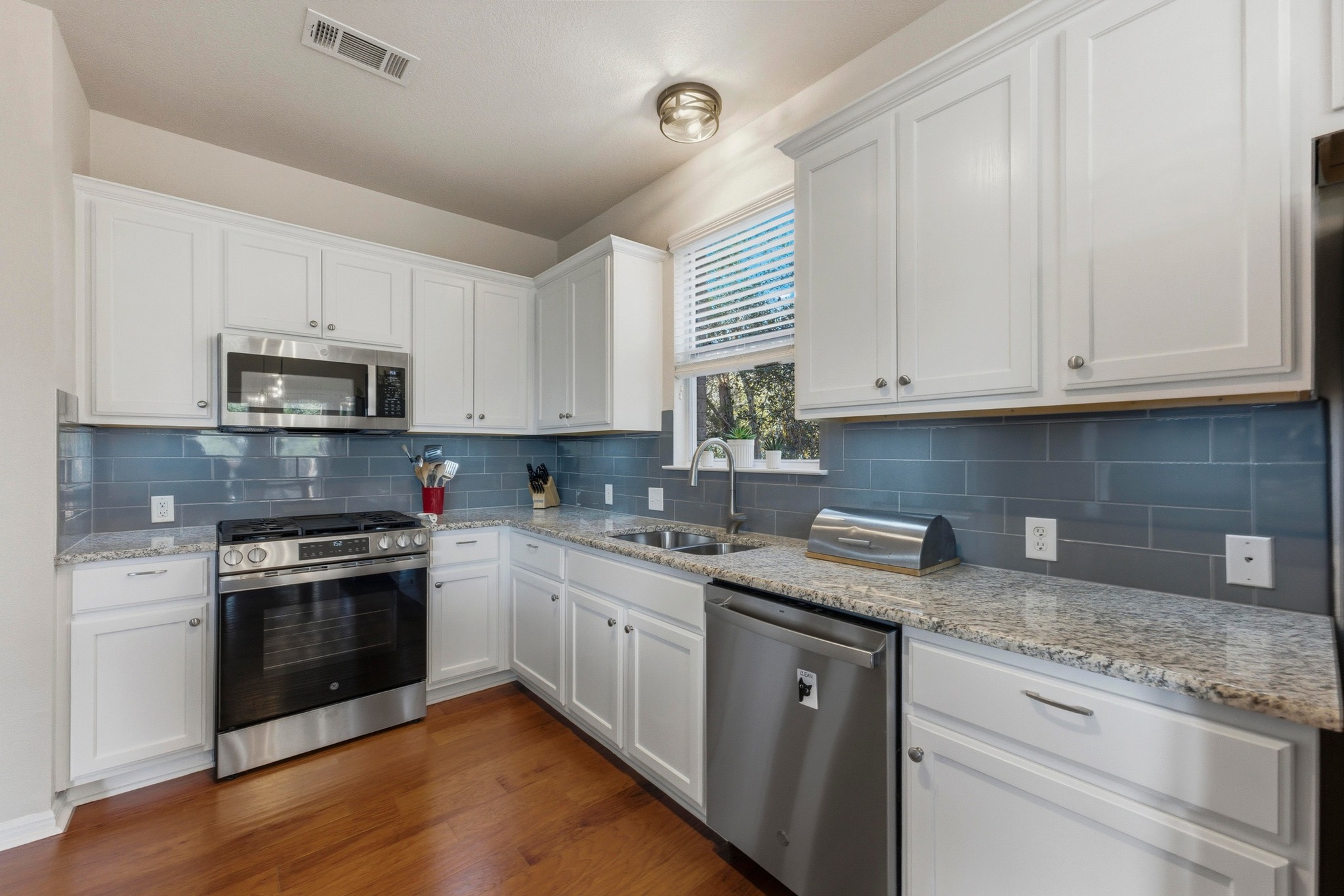 7805 Pitter Pat Lane Austin, TX 78736 - Photo 16 of 40 a kitchen with stainless steel appliances granite countertop a sink and a stove