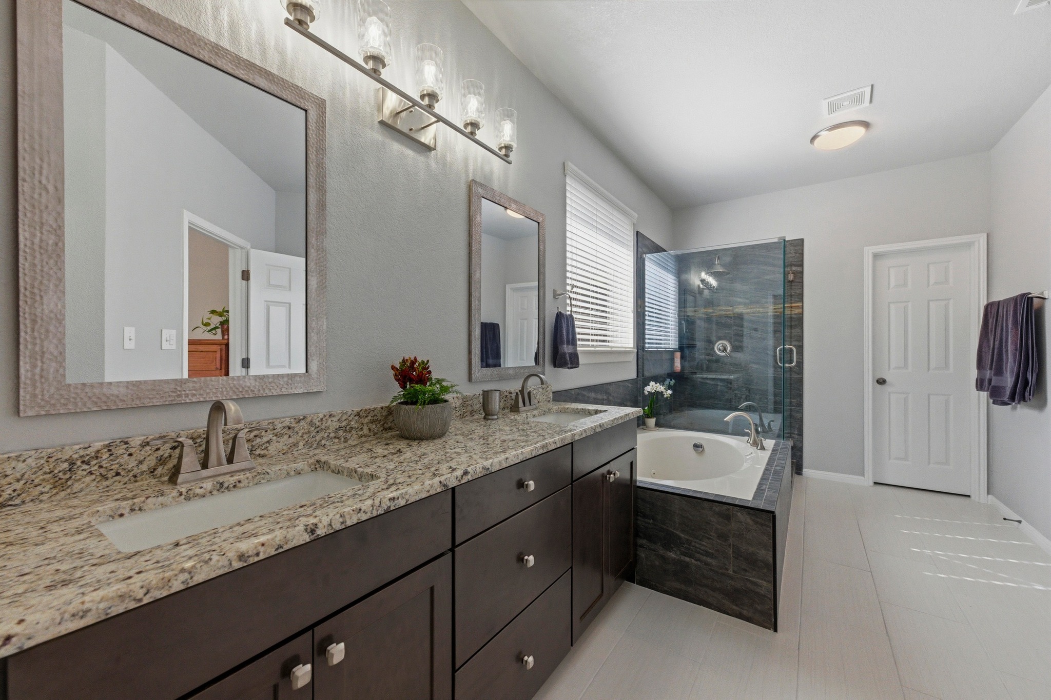 7805 Pitter Pat Lane Austin, TX 78736 - Photo 20 of 40 a spacious bathroom with a granite countertop sink mirror and double
