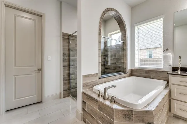 a bath tub sitting in a bathroom next to a window