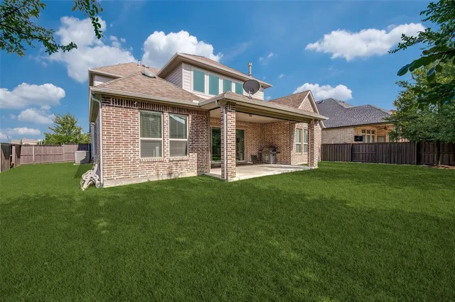 a front view of a house with a garden and plants