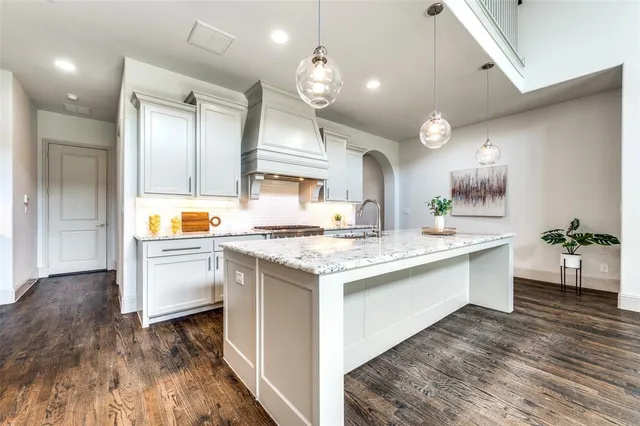 a kitchen with a stove and cabinets