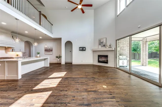 a large hall with kitchen view and a fireplace