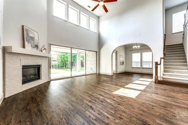 a view of a livingroom with wooden floor and a fireplace
